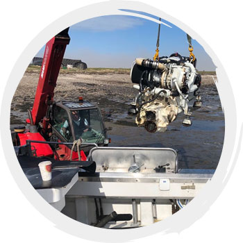 Boat engine being lifted by crane